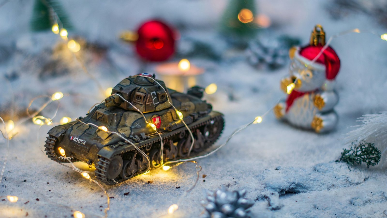 A toy tank with lights on it sitting in the snow