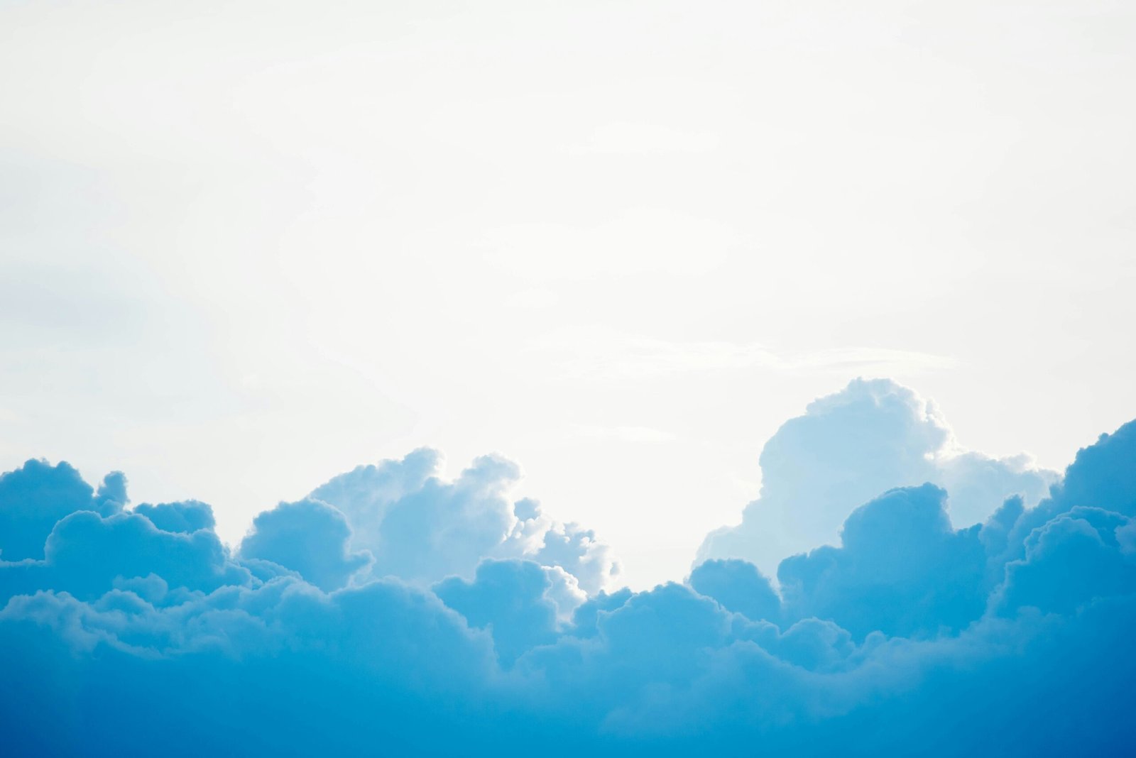 blue clouds under white sky